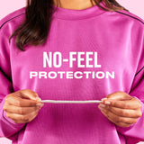 Person wearing a pink sweatshirt with 'NO-FEEL PROTECTION' text, holding a thin Carefree liner.