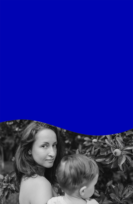 Woman holding baby in garden